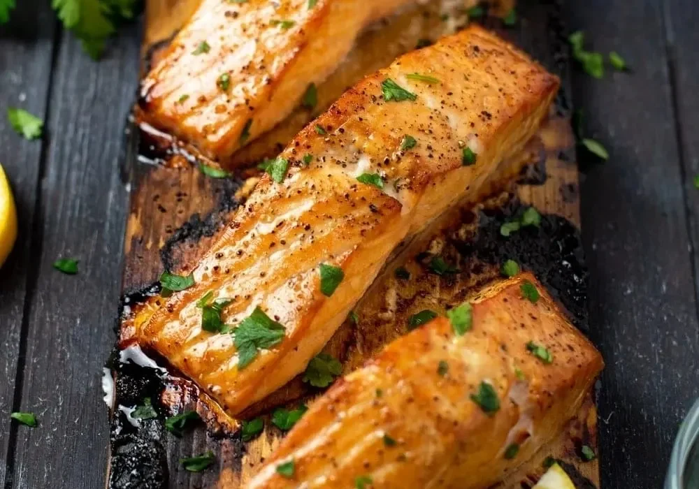 Grilled salmon fillets with lemon and herbs.